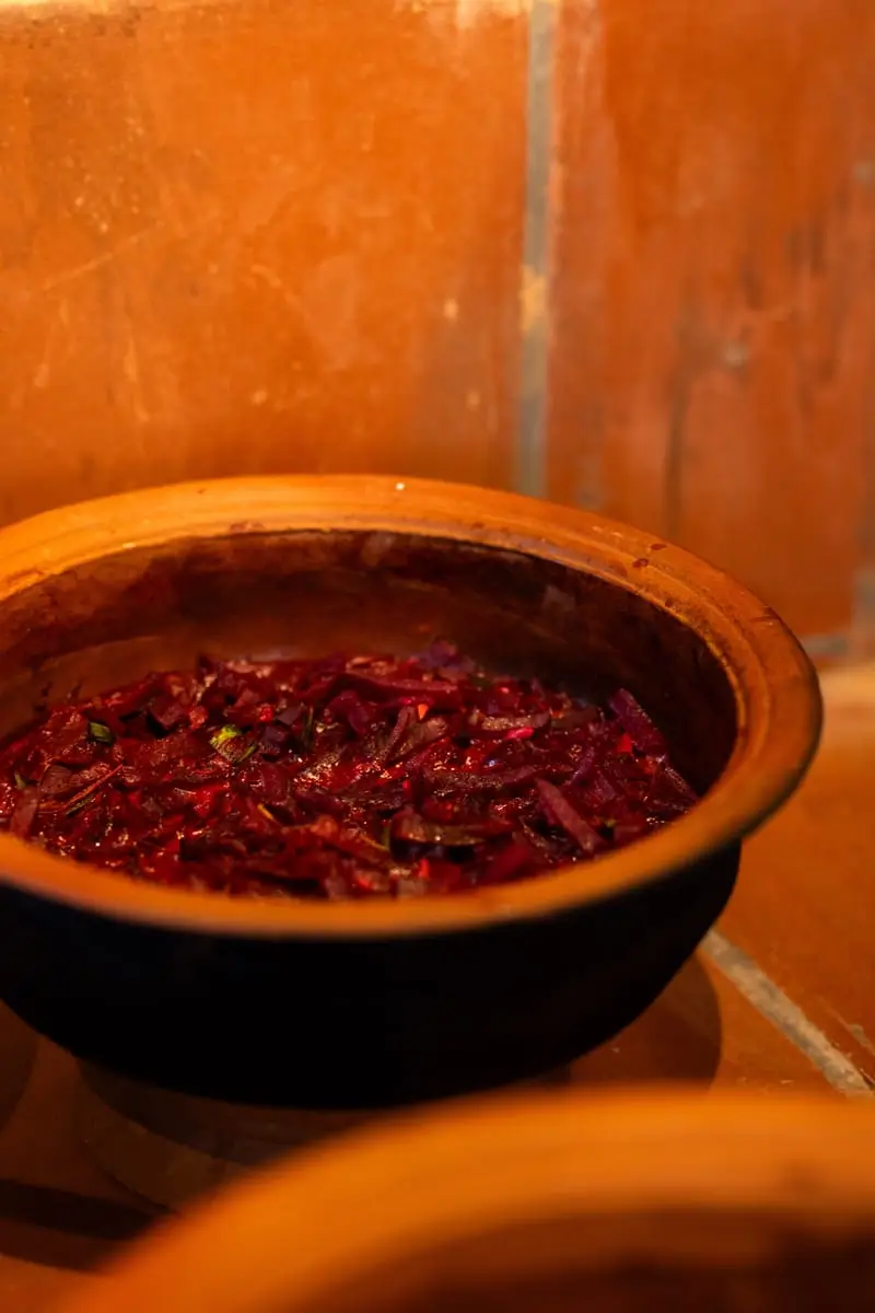 Beetroot curry in a clay pot on the hearth
