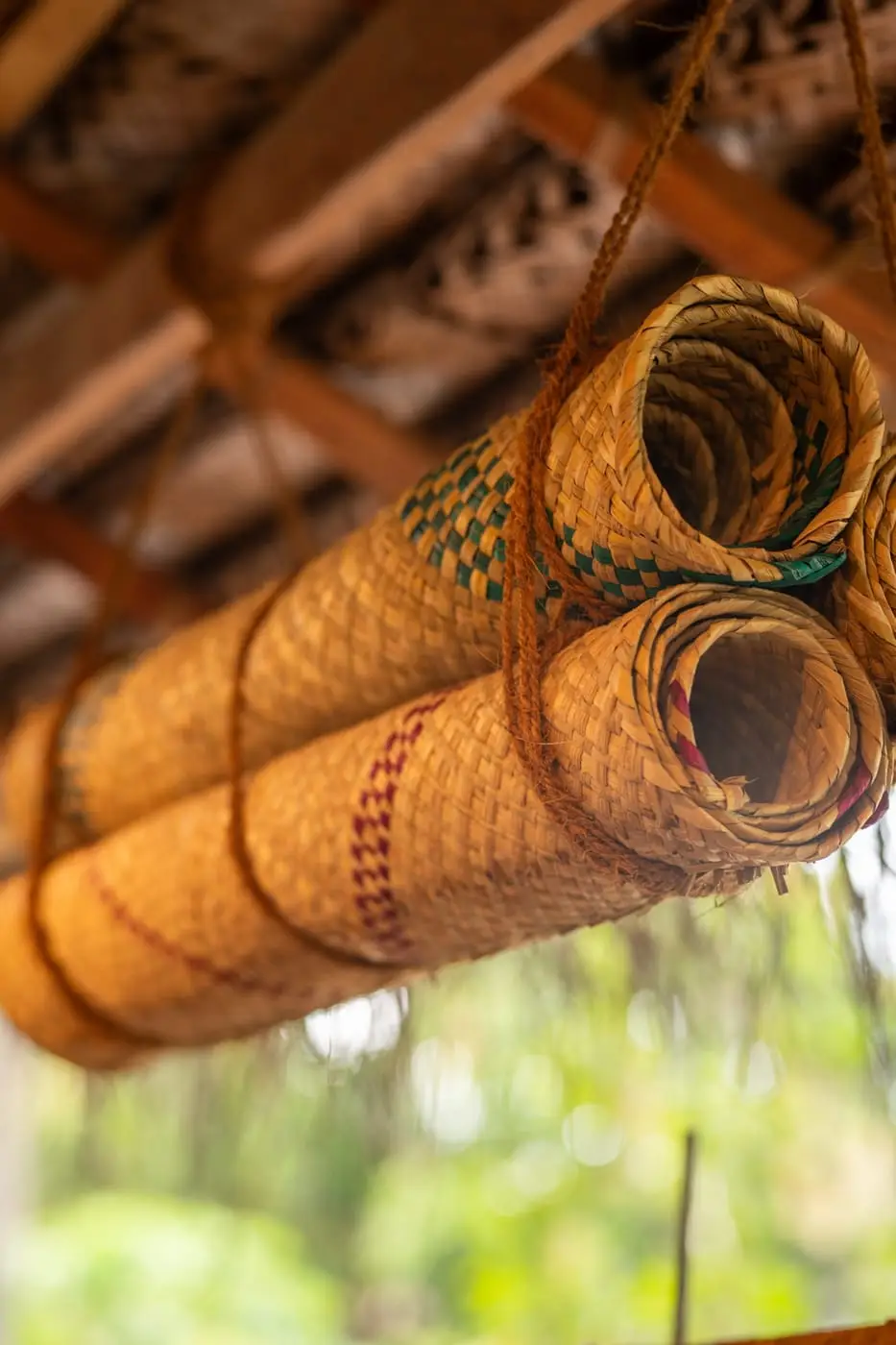 Rolled woven mats hanging from the rafters
